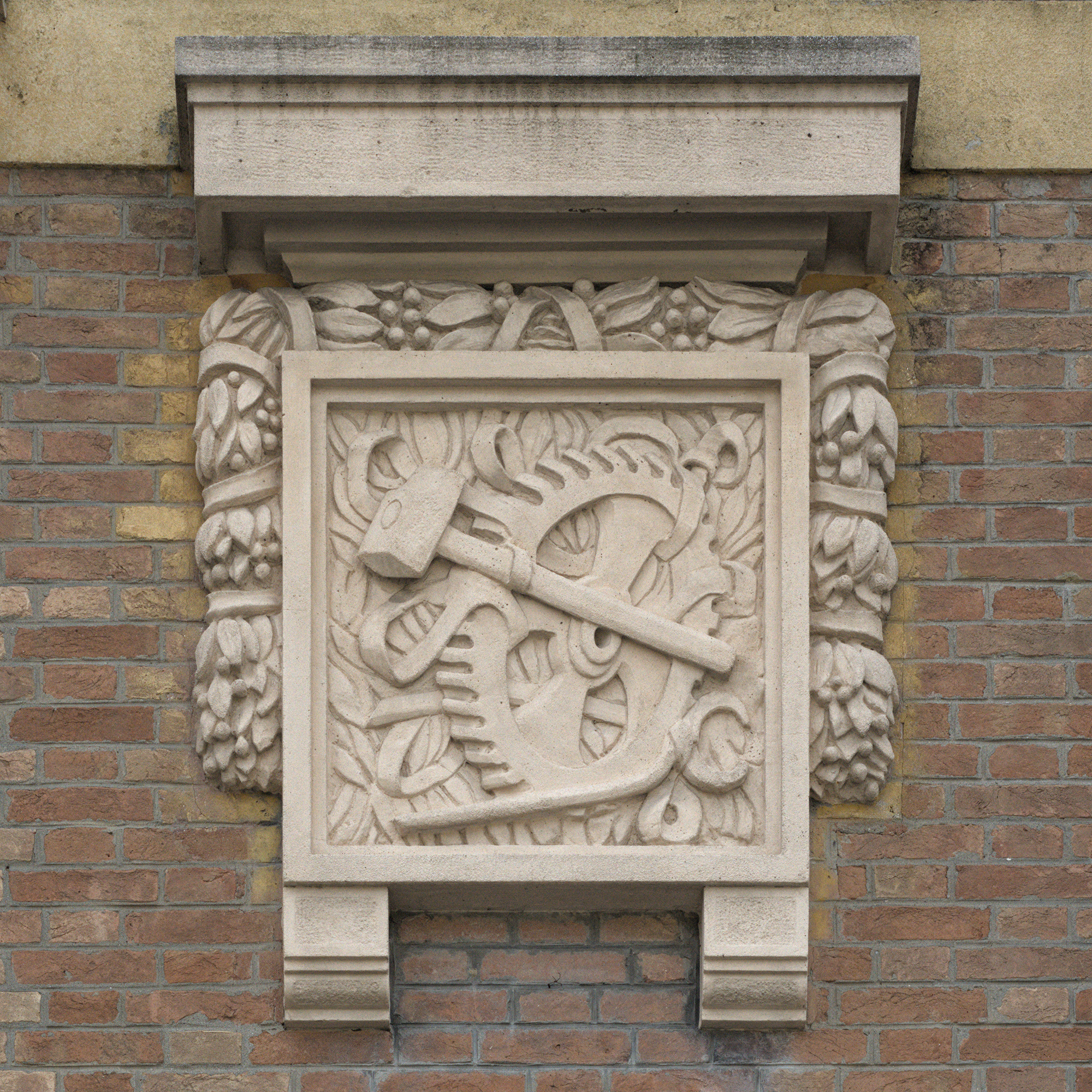 Autore non identificato, uno dei due bassorilievi raffiguranti dettagli meccanici e attrezzi da lavoro della facciata di casa Galtarossa, imprenditore delle omonime officine, primo quarto del XX secolo, via Alberto Mario 6, Padova